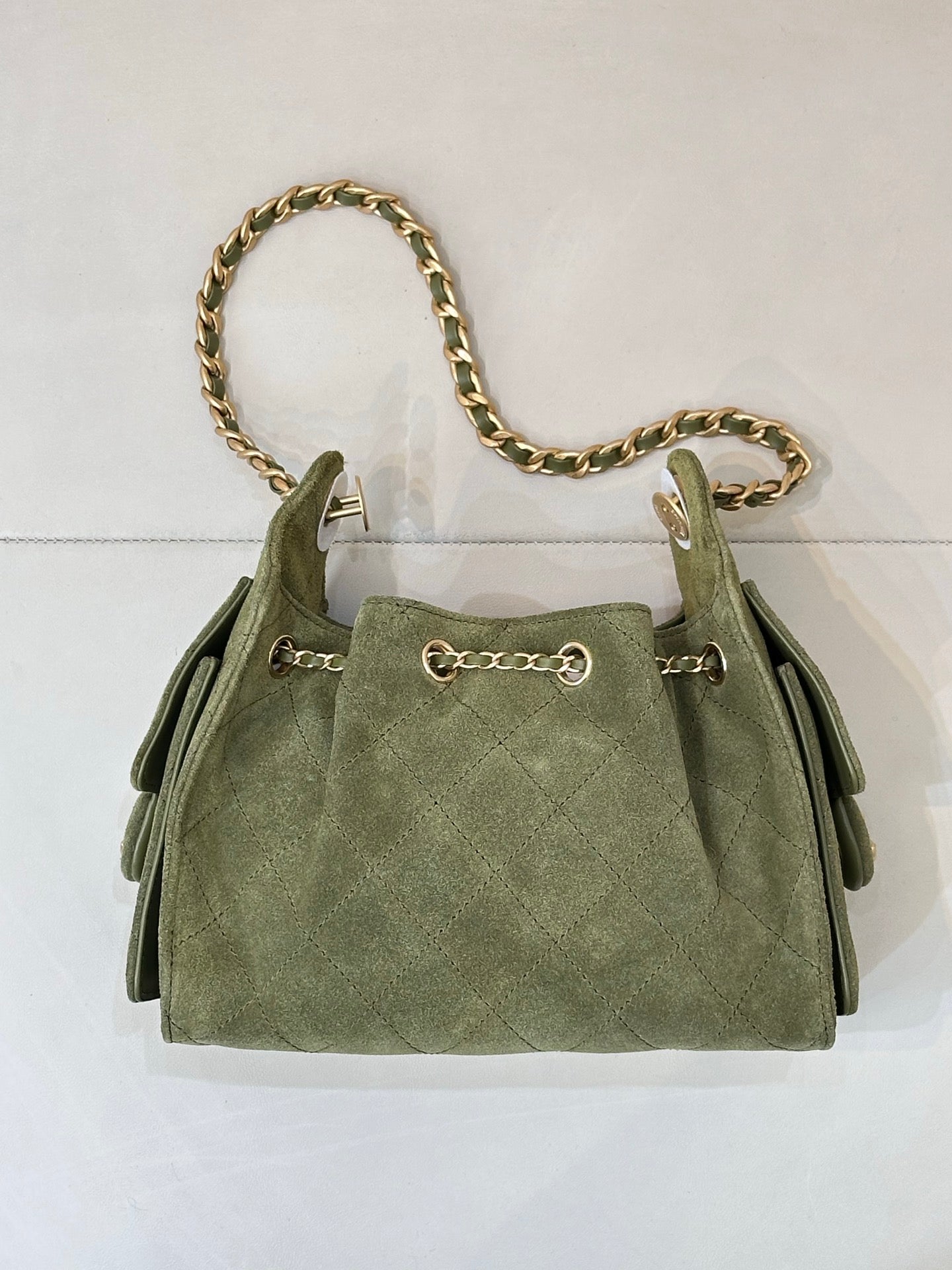 Chanel mini handbag in olive green with gold chain shoulder strap and two side tabs
