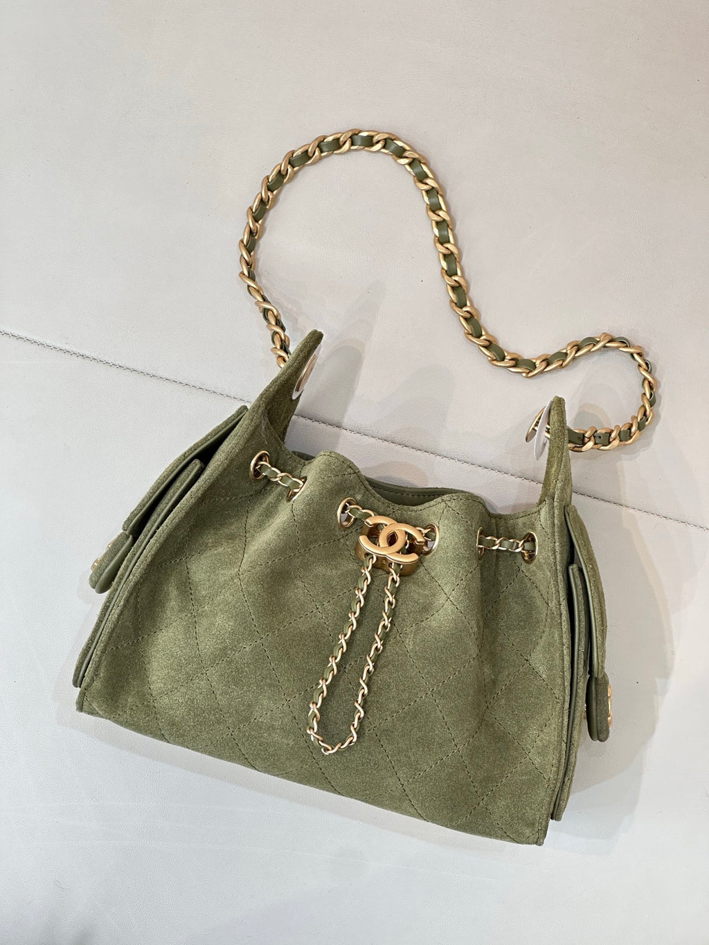 Chanel mini handbag in olive green with gold chain handle and front clasp detail