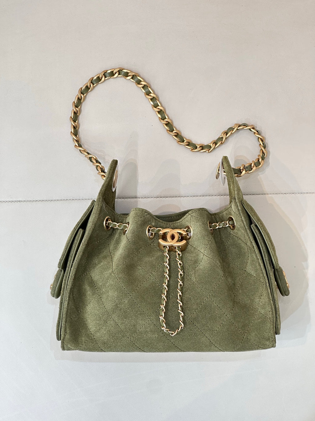Chanel mini handbag in olive green with gold chain shoulder strap and front charm