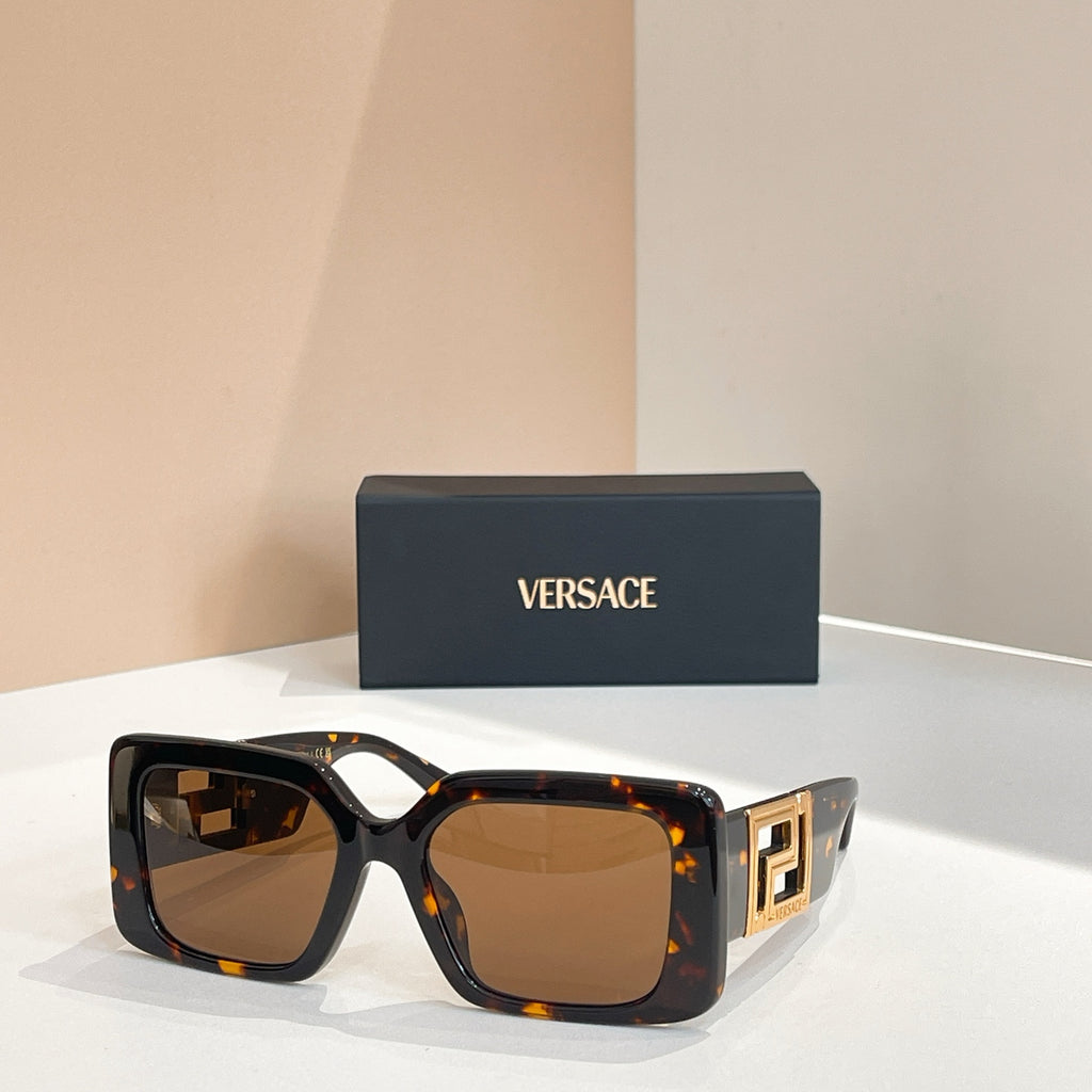 Black and tortoiseshell square sunglasses with gold Versace logo temples and brown lenses.