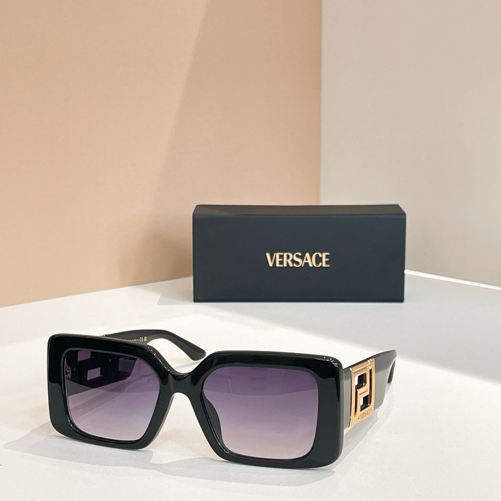 Black square sunglasses with gold Versace logo temples and purple-tinted lenses.