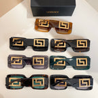 Tray of assorted square sunglasses with gold Versace logo temples and varied lenses.
