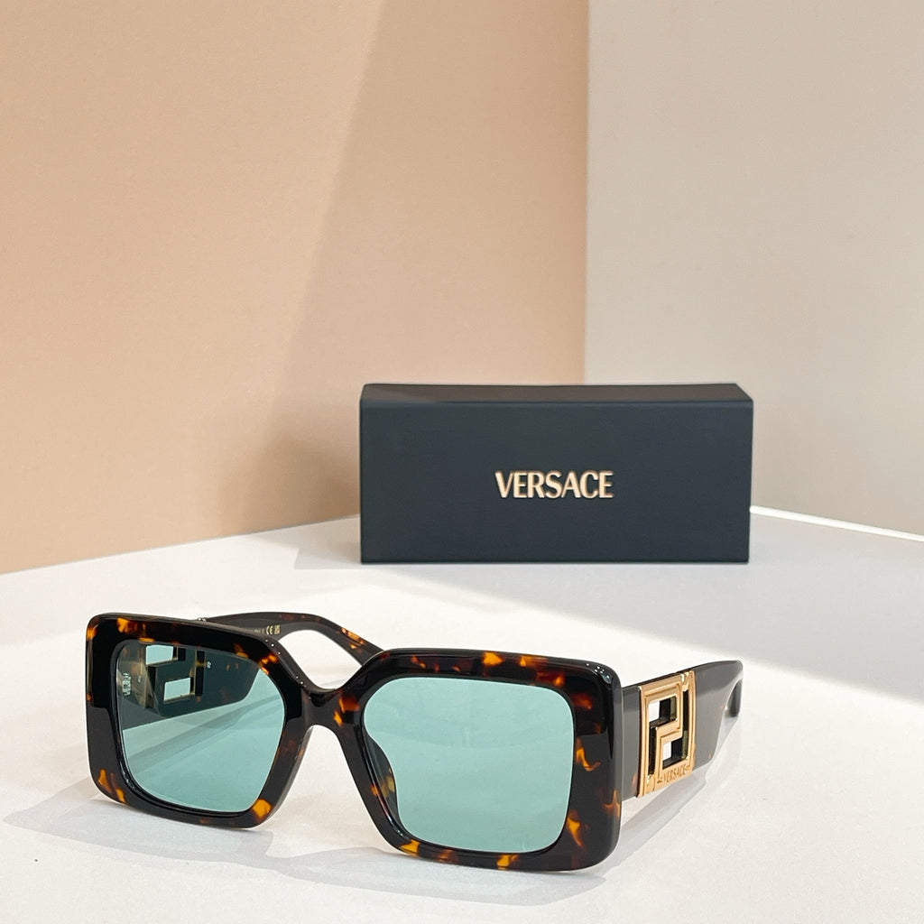 Tortoiseshell square sunglasses with gold Versace logo temples and light aqua lenses.