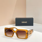 Amber square sunglasses with gold Versace logo temples and dark lenses.