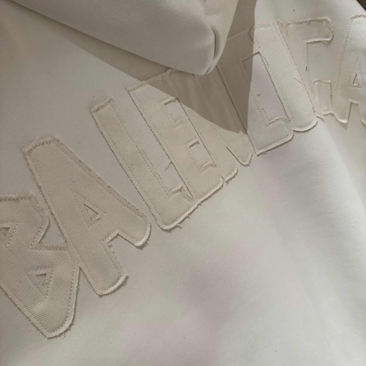 Balenciaga long hoodie with raised embroidered logo lettering on front panel