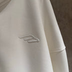 Balenciaga long hoodie sleeve with small embroidered logo on white fabric