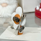 Louis Vuitton keychain charm standing: white flower wings, orange body, silver fittings and ring