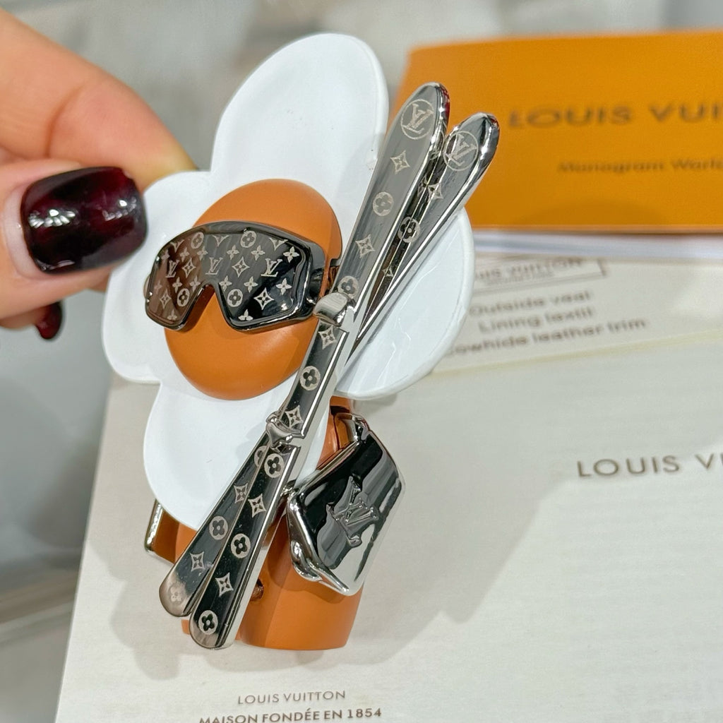 Louis Vuitton keychain charms with orange leather, black monogram panels, silver clips