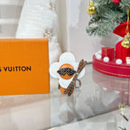 Louis Vuitton keychain charm featuring white flower wings and orange figure with silver hardware