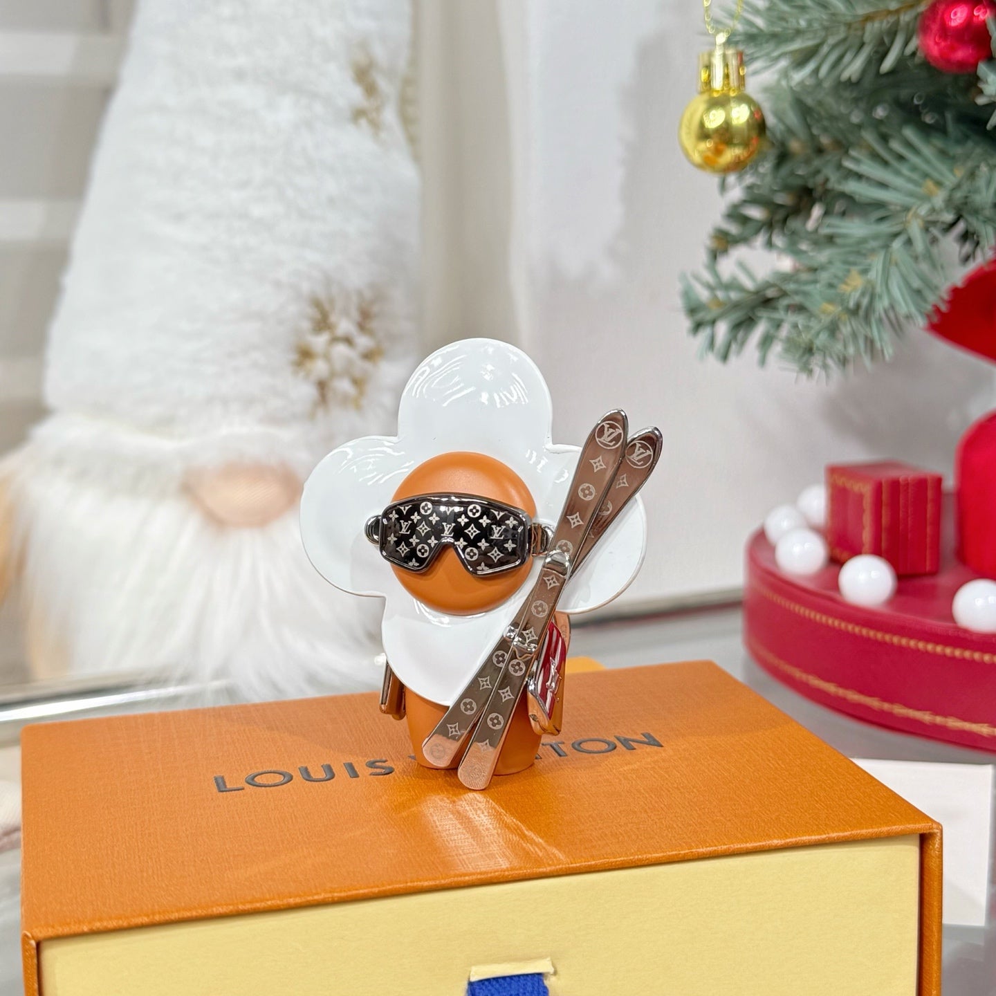 Louis Vuitton keychain charm: white flower wings, orange body, brown strap and silver keyring