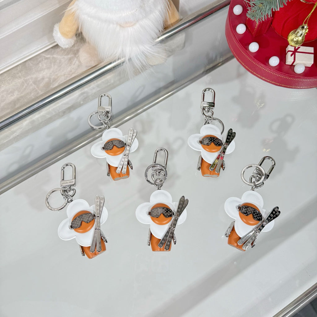 Louis Vuitton keychain charms with white caps, orange leather, black patterned tops