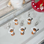 Louis Vuitton keychain charms with white caps, orange leather, black patterned tops