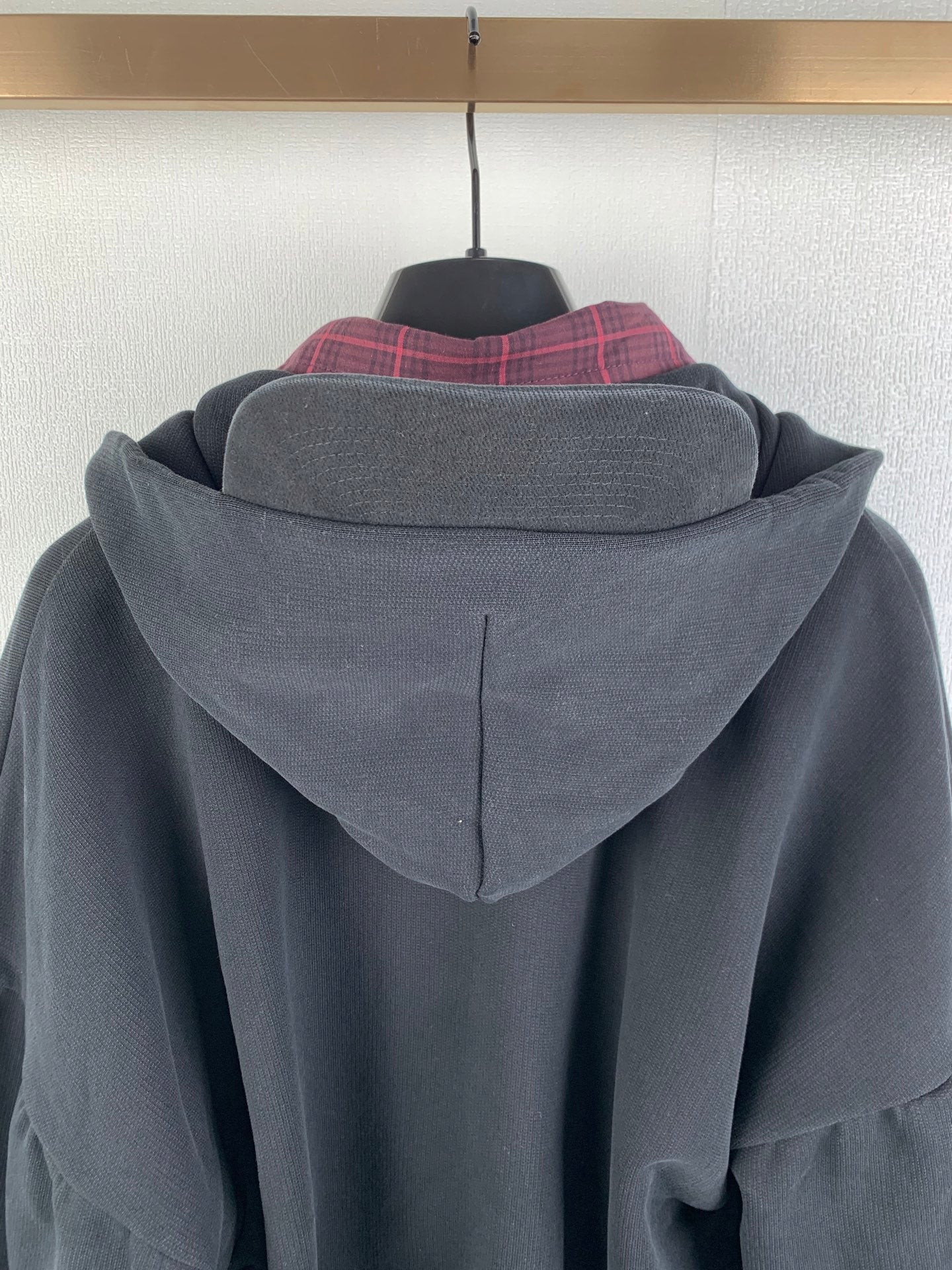 Balenciaga hooded jacket back close-up with center seam and plaid inner collar layer