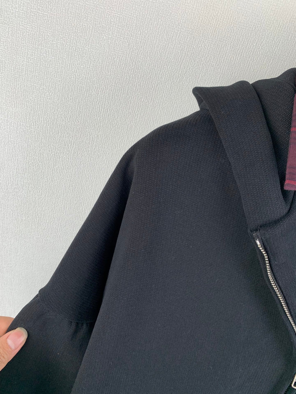 Balenciaga hooded jacket shoulder close-up with zipper edge and ribbed sleeve cuff