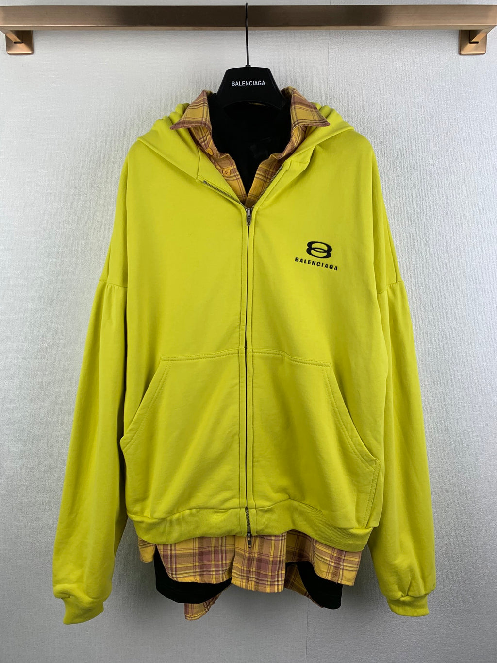 Zip-up hooded jacket in bright lime green with logo patch and plaid-lined collar