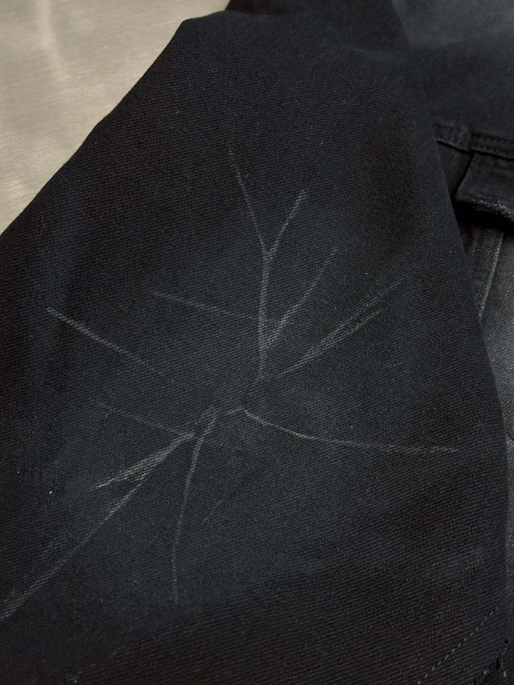 Dark blue hooded jacket with subtle starburst fabric pattern