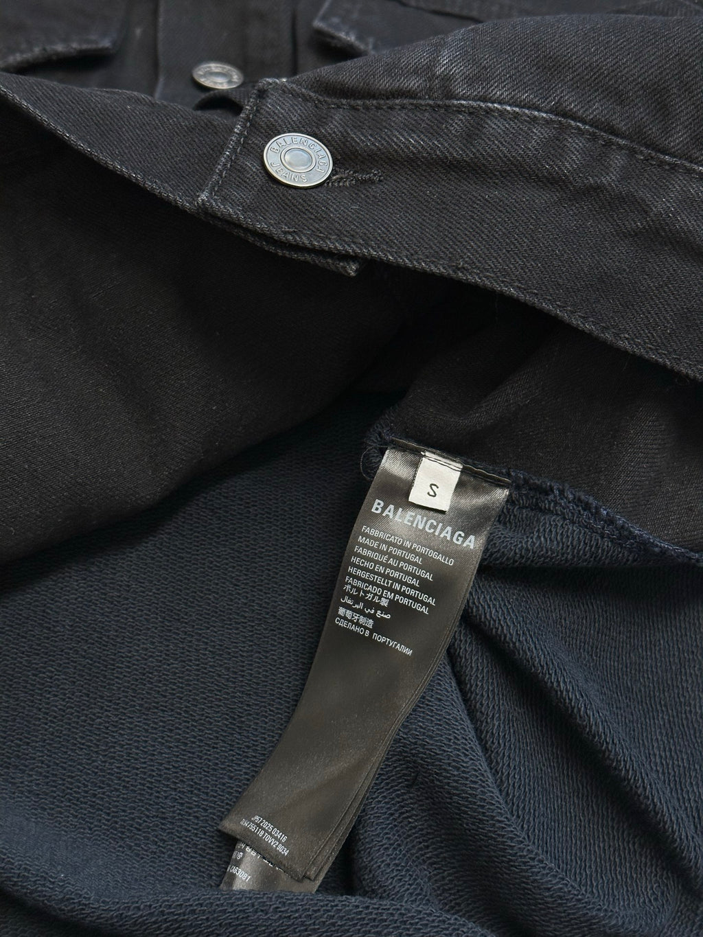 Dark blue hooded denim jacket with coin snap and size/brand care label