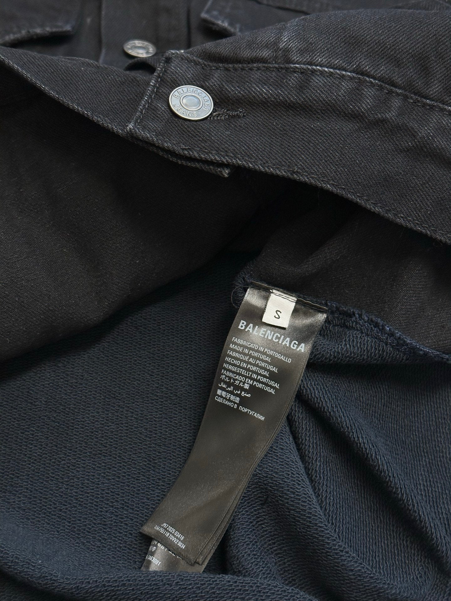 Dark blue hooded denim jacket with coin snap and size/brand care label