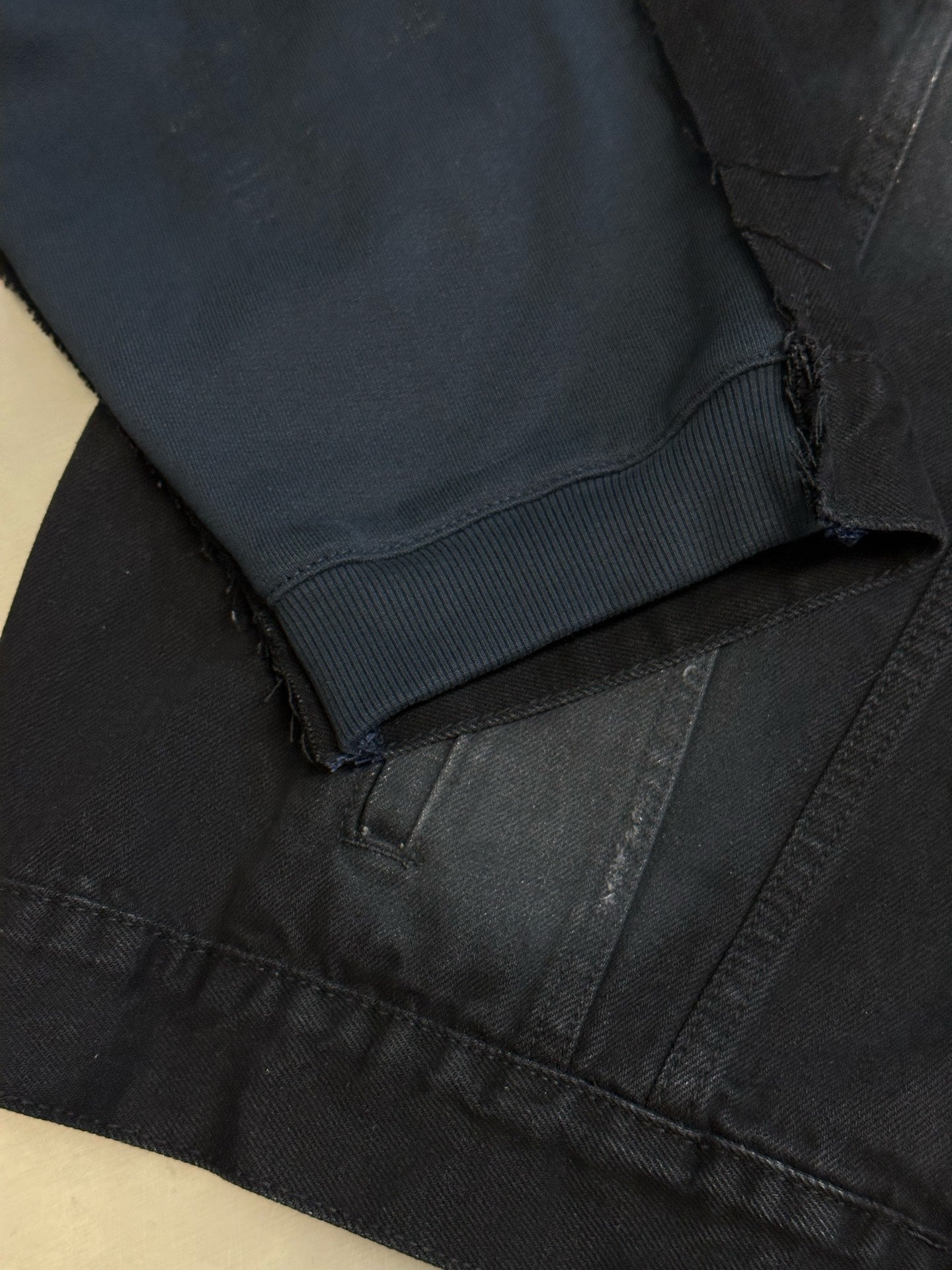 Dark blue hooded denim jacket cuff and pocket hem detail