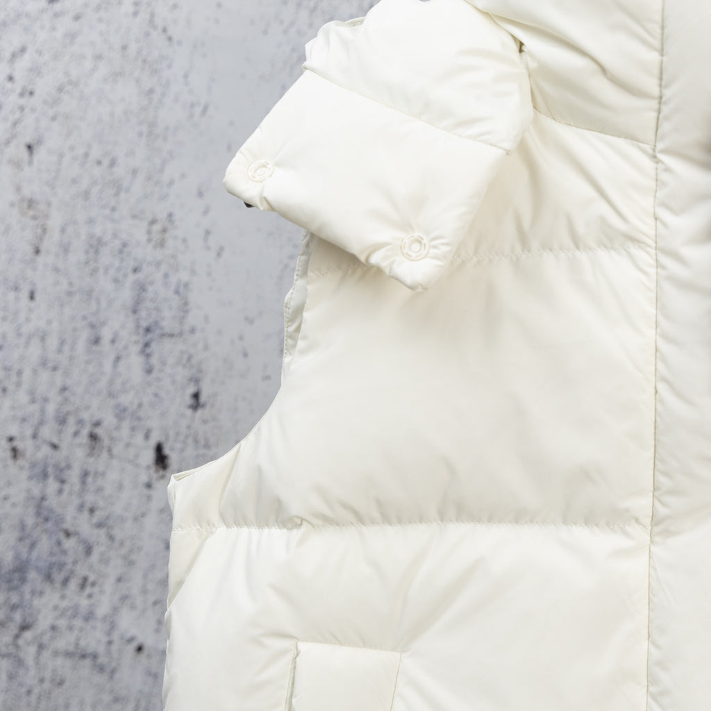 White puffer jacket shoulder and sleeve with quilted padding and cuff detail