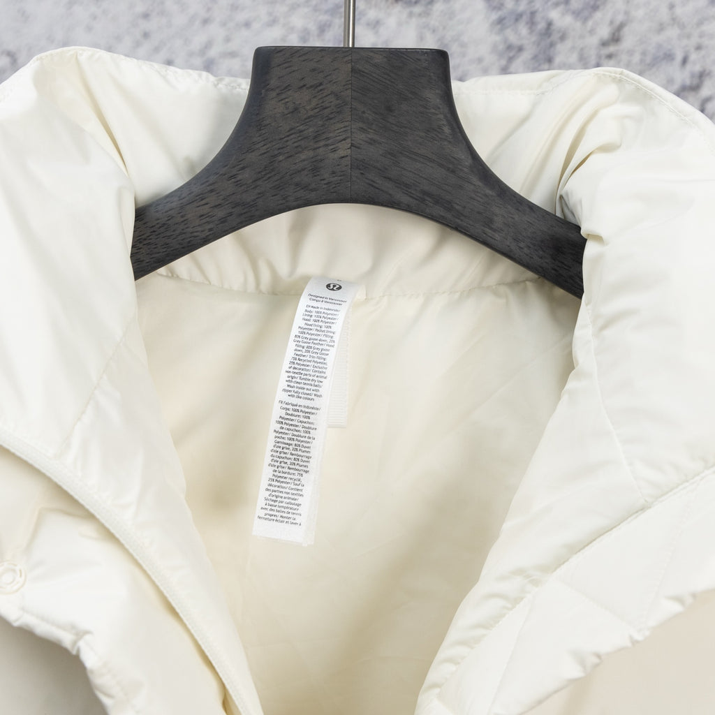 White puffer jacket back panel with care label on the lining and quilting