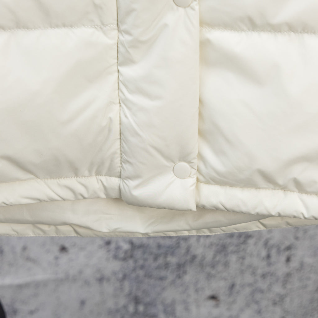 White puffer jacket center front panel with snap button and vertical seam