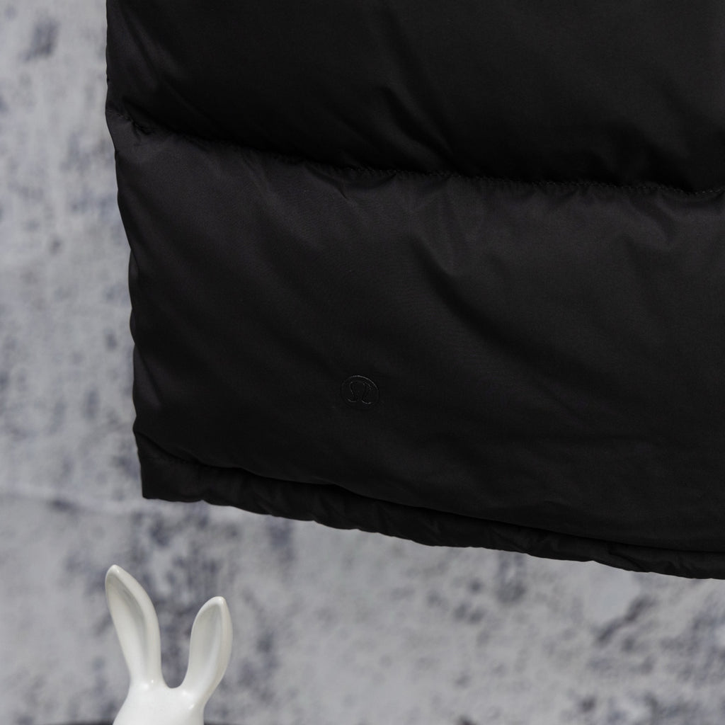 Black puffer vest side panel with small embossed logo