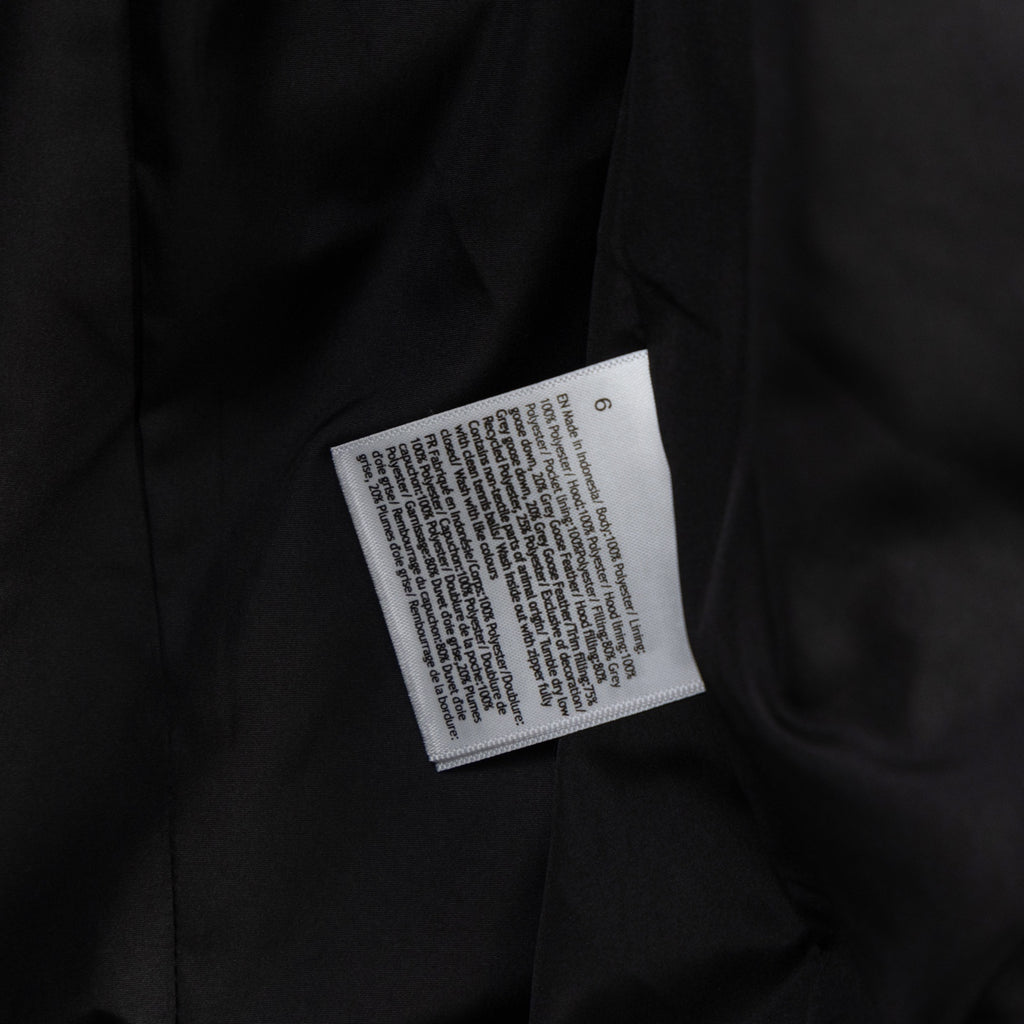 Black puffer vest care label on inner seam