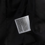 Black puffer vest care label on inner seam