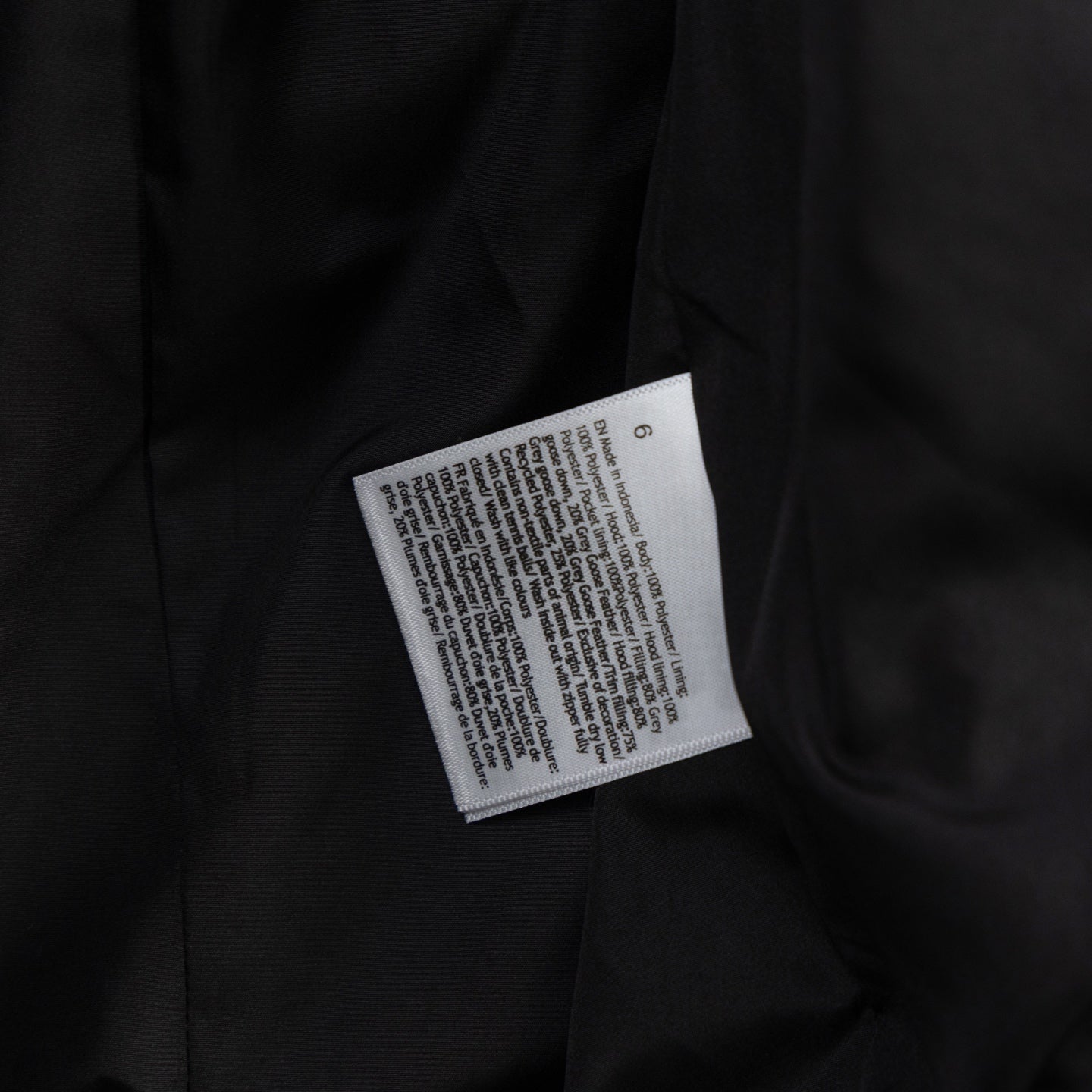 Black puffer vest care label on inner seam