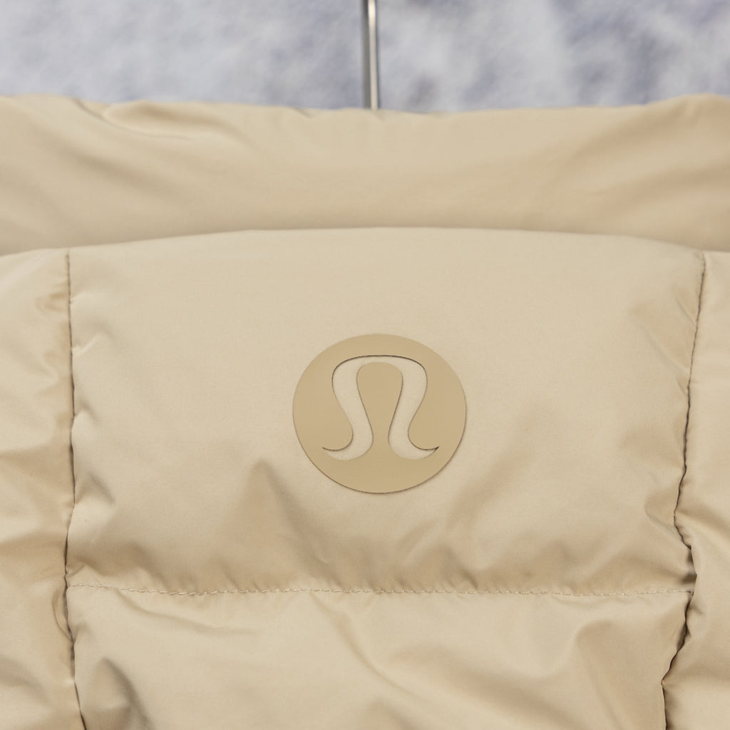 Tan puffer jacket back panel with embossed logo