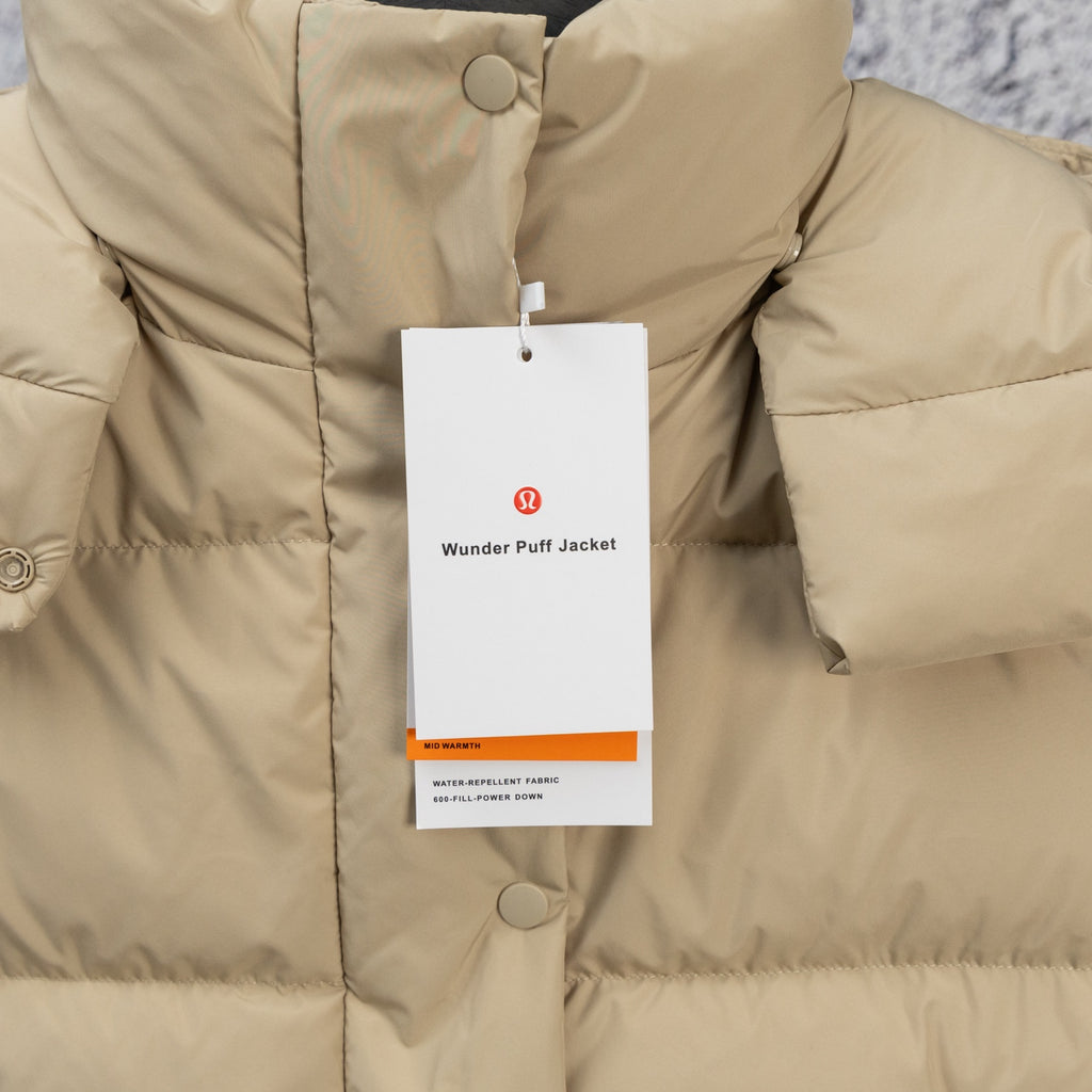Beige puffer jacket front with snap buttons, quilted texture, and hanging tag