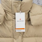 Beige puffer jacket front with snap buttons, quilted texture, and hanging tag