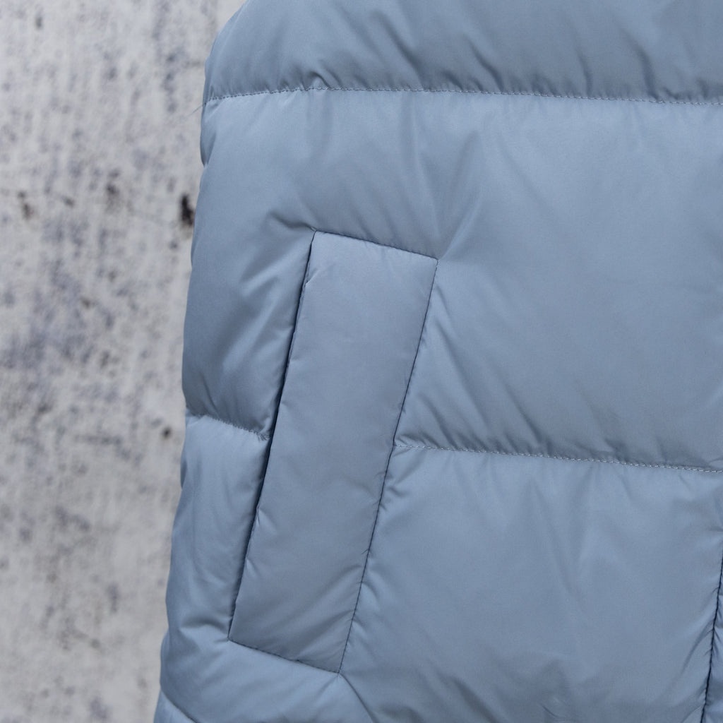 Light blue puffer vest back panel with stitched quilt box and seam lines