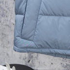 Light blue puffer vest hem with quilted panels and textured fabric finish