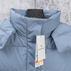 Light blue puffer vest close-up with stand collar and snap button placket