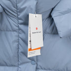 Light blue puffer vest with product tag on front and visible quilting seams