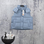 Light blue quilted puffer vest with front zipper and stand collar