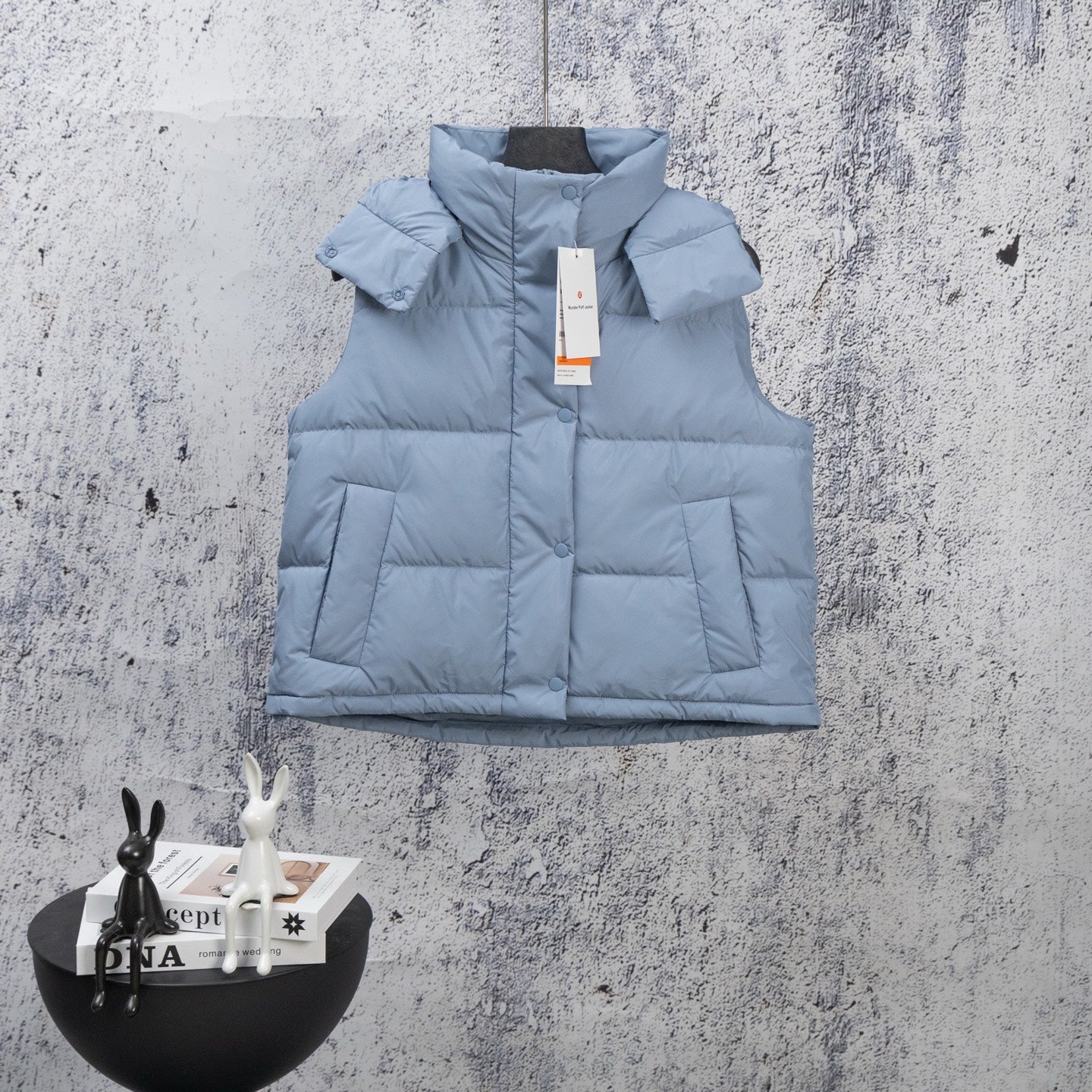 Light blue quilted puffer vest with front zipper and stand collar