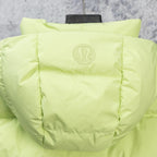 Lime green hooded puffer vest with padded hood and central logo