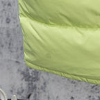 Lime green hooded puffer vest with logo patch on the front panel