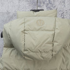 Light sage puffer vest back with centered oval emblem and quilted shoulders