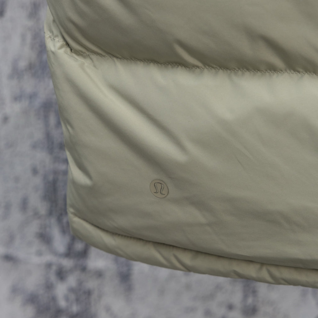 Light green puffer vest side with small logo on lower panel