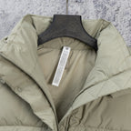 Light sage puffer vest interior lining view with garment label at the neckline