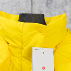 Yellow puffer jacket hood detail with circular button and hang tag