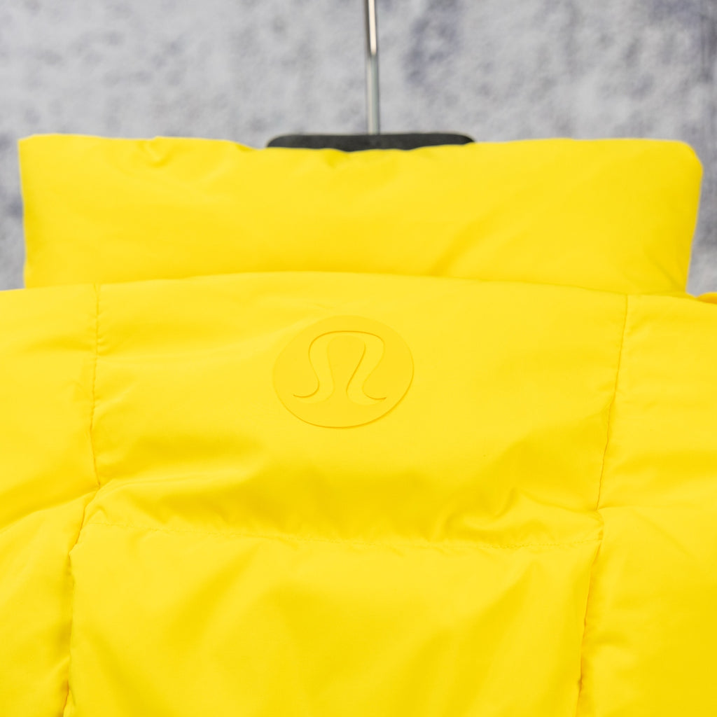 Yellow puffer jacket hood with small embossed logo