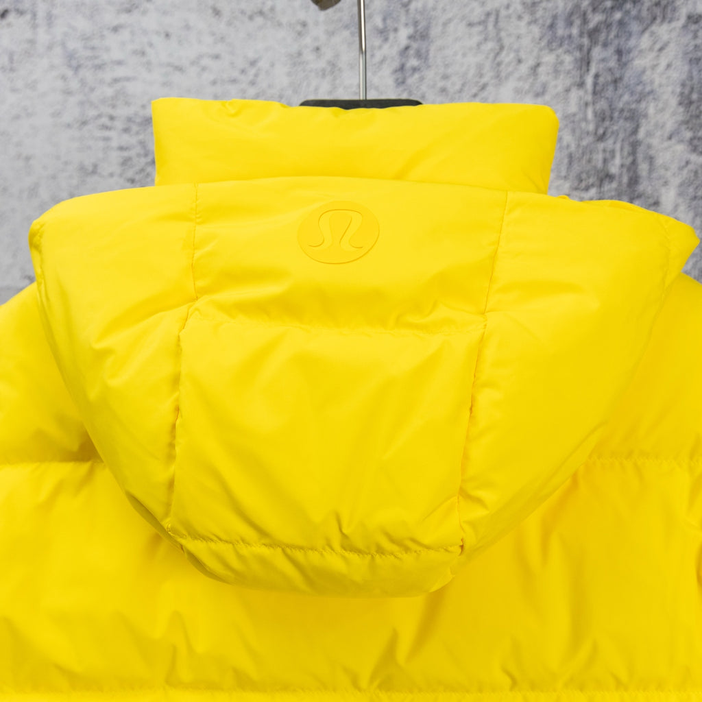 Yellow puffer jacket with adjustable hood and stitched back yoke