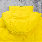 Yellow puffer jacket with adjustable hood and stitched back yoke