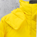 Yellow puffer jacket sleeve and shoulder with quilted insulation