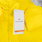 Yellow puffer jacket detail with hang tag and smooth quilted panels